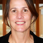 headshot of a person in front of a bookcase